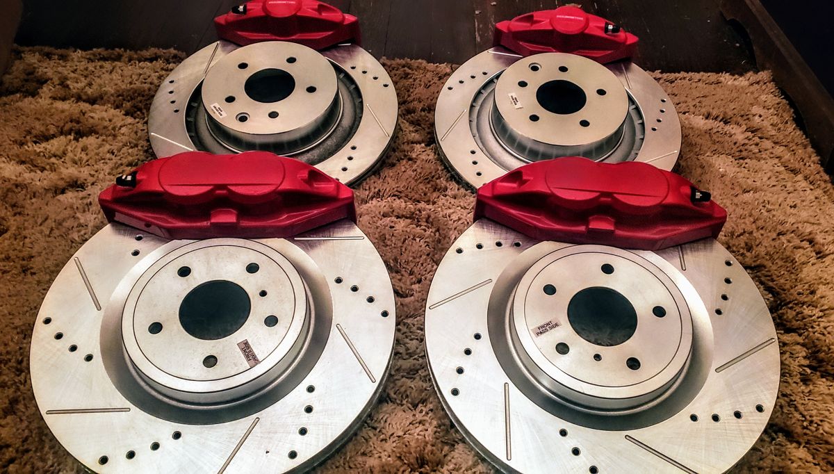 Four red 370Z Akebono calipers with drilled and slotted rotors