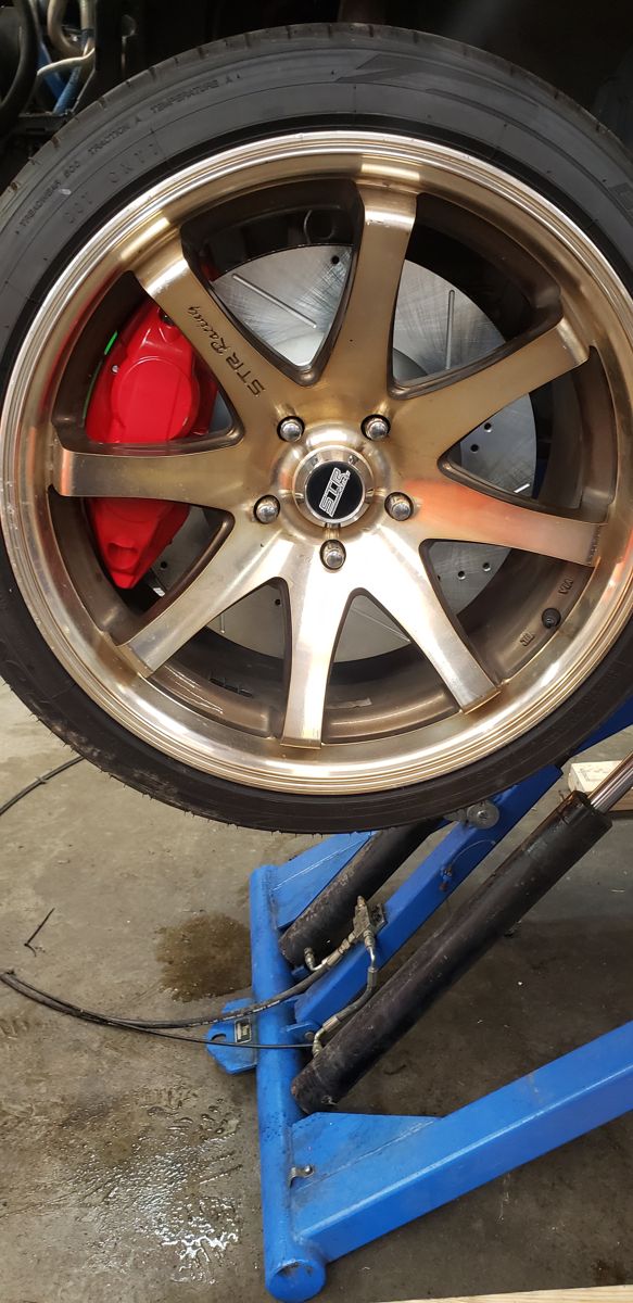 Caliper visible behind the wheel spokes