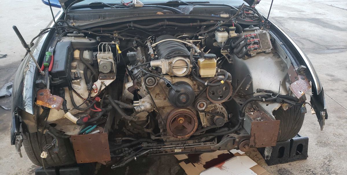 LS2 in the engine bay of an '06 Pontiac GTO mid-teardown