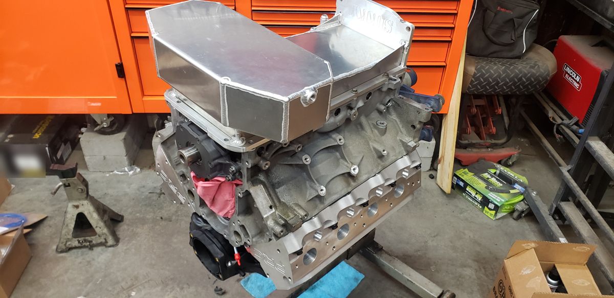 Long block with PRC heads and aluminum oil pan on an engine stand