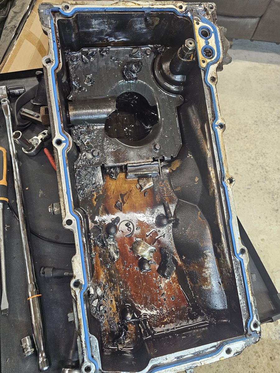 Oil pan from the old 4.8 with metal chunks and debris inside