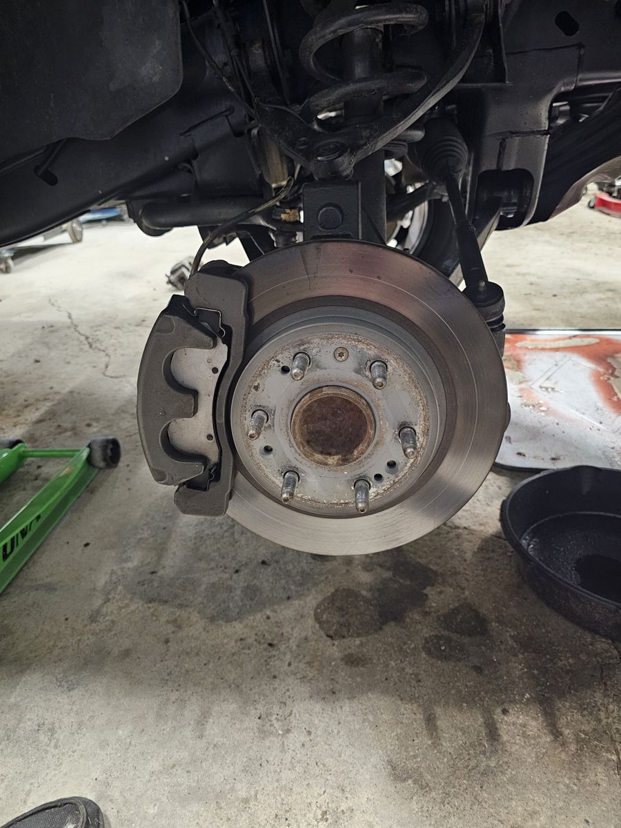 Before: stock 2-piston sliding caliper and rotor