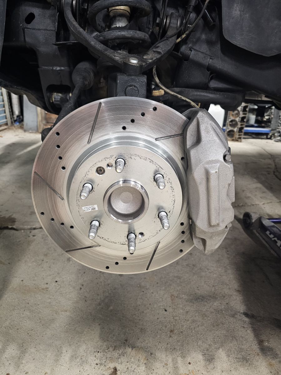 Passenger side: 4-piston caliper and new rotor