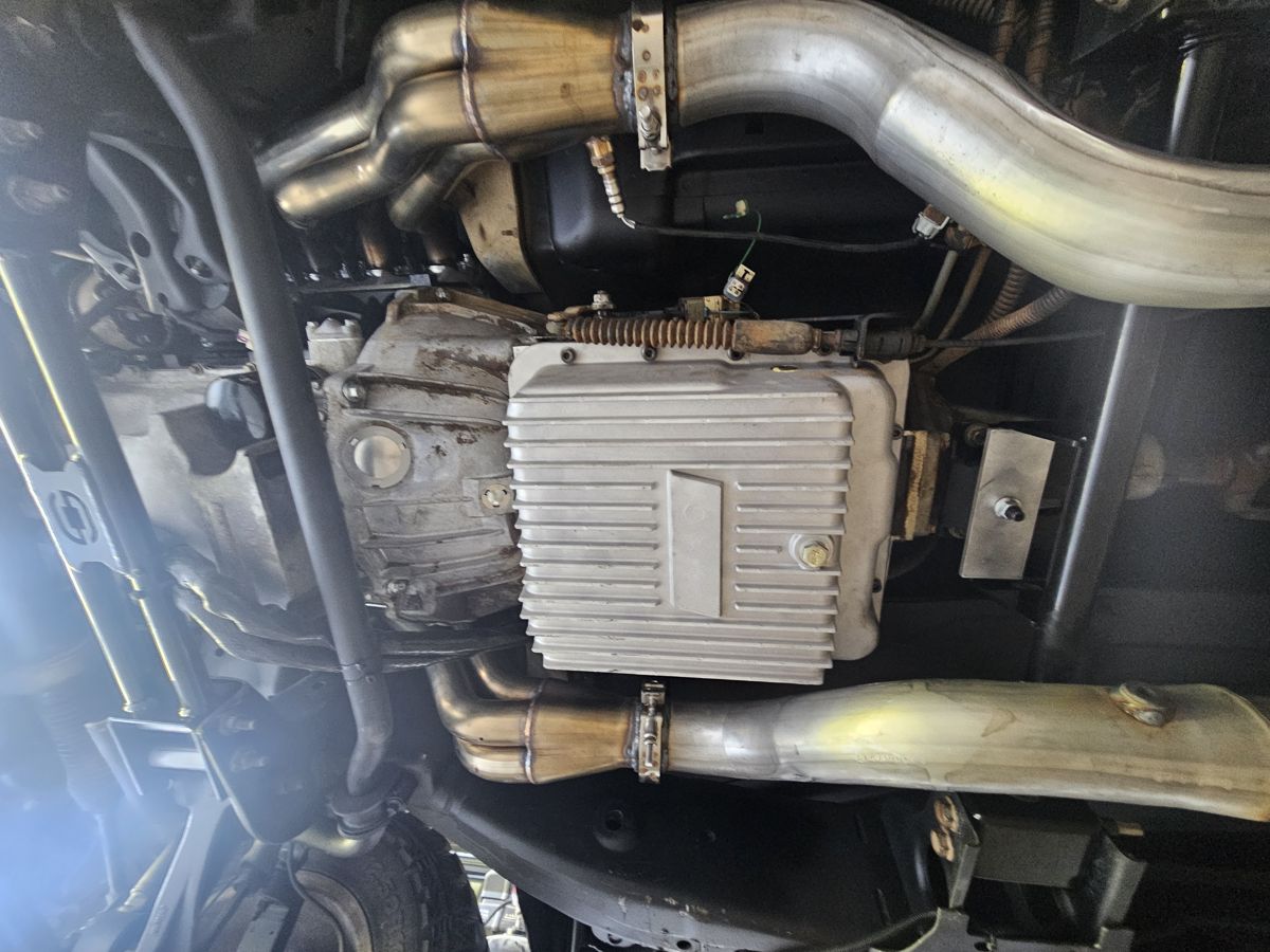 Underneath: headers into the 3" pipes past the deep trans pan