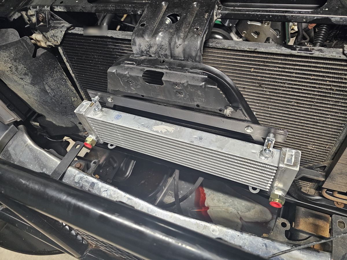 Transmission cooler mounted ahead of the radiator