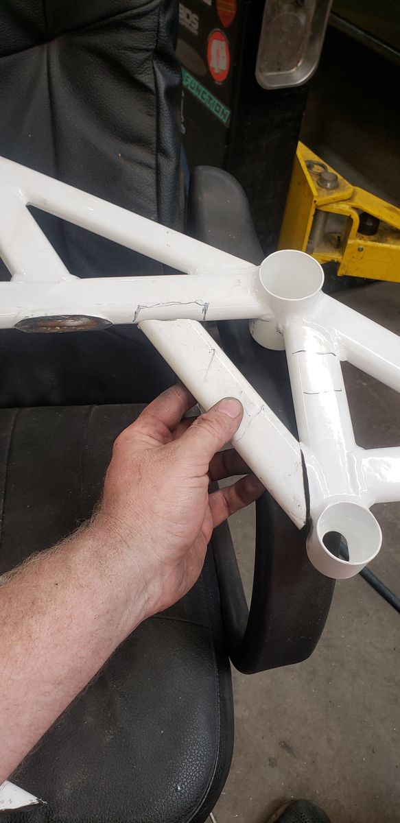 Cut brace leg held up in its new position before rewelding