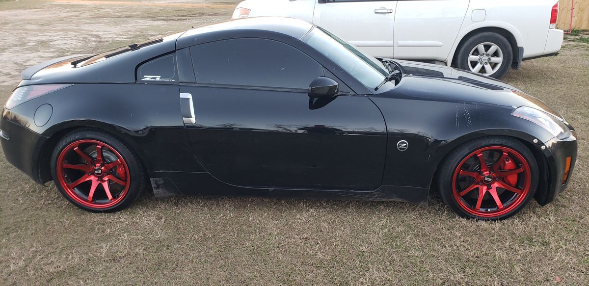 Black LS-swapped 350Z on red wheels with red Akebono calipers